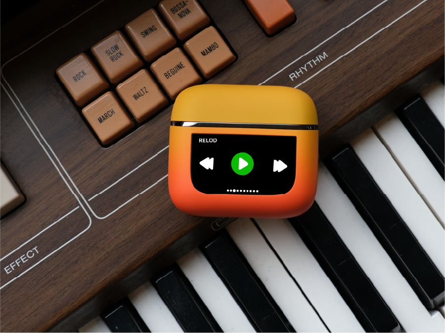 RELOD TouchBud wireless earbuds with music player icons on a keyboard