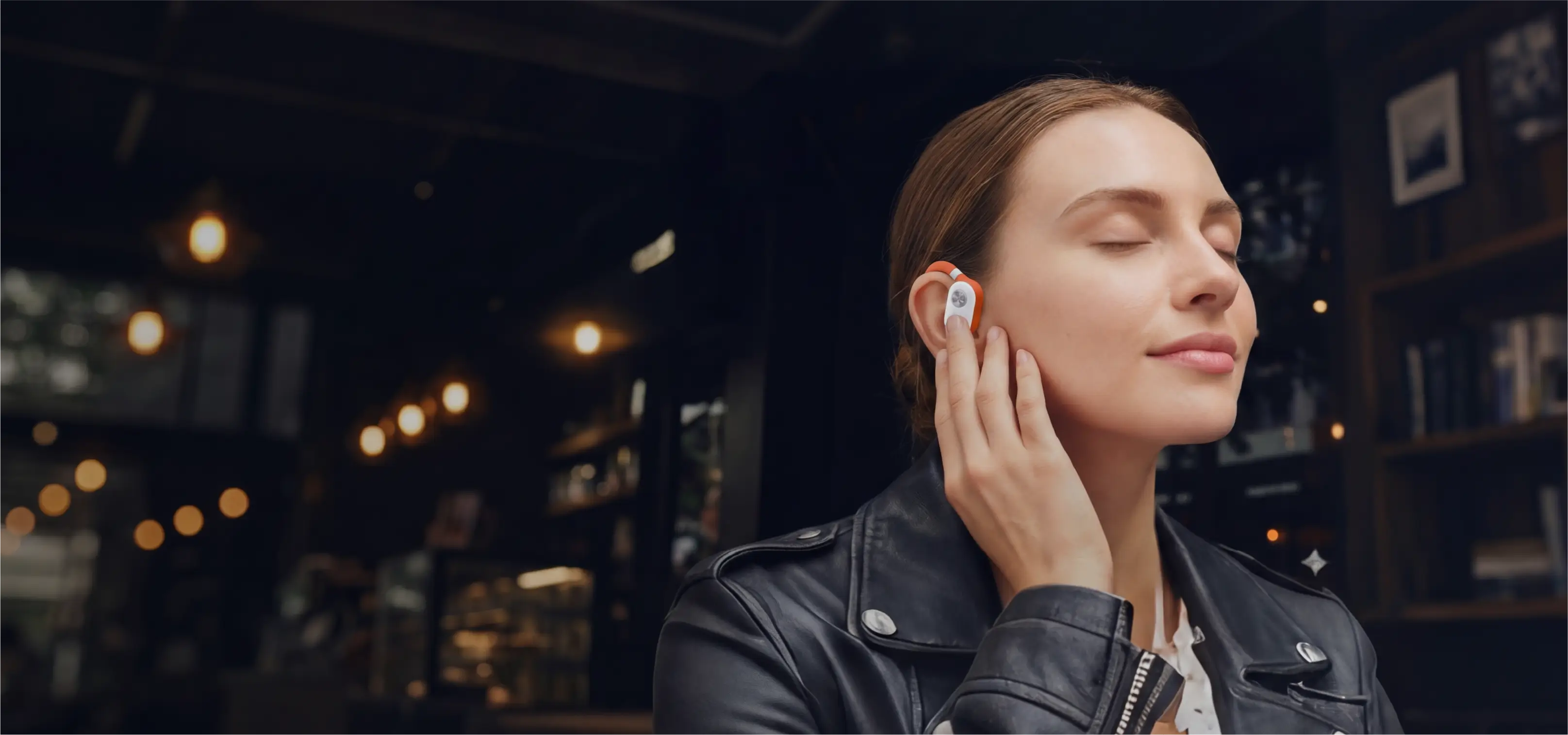 Woman wearing RELOD TouchFit PRO wireless earbuds in a dimly lit roomslider_item_Yp4ajw