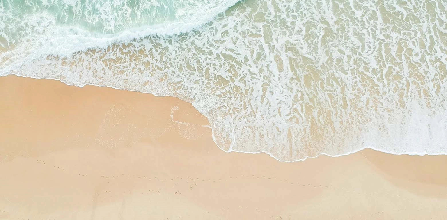 Close-up of waves crashing onto a sandy beach